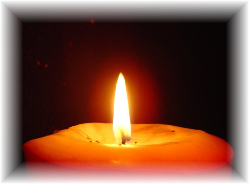 lit candle in dark