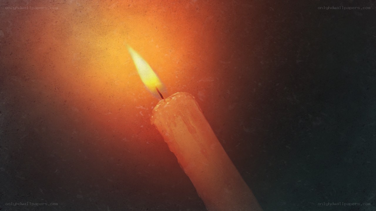 lit candle in dark room