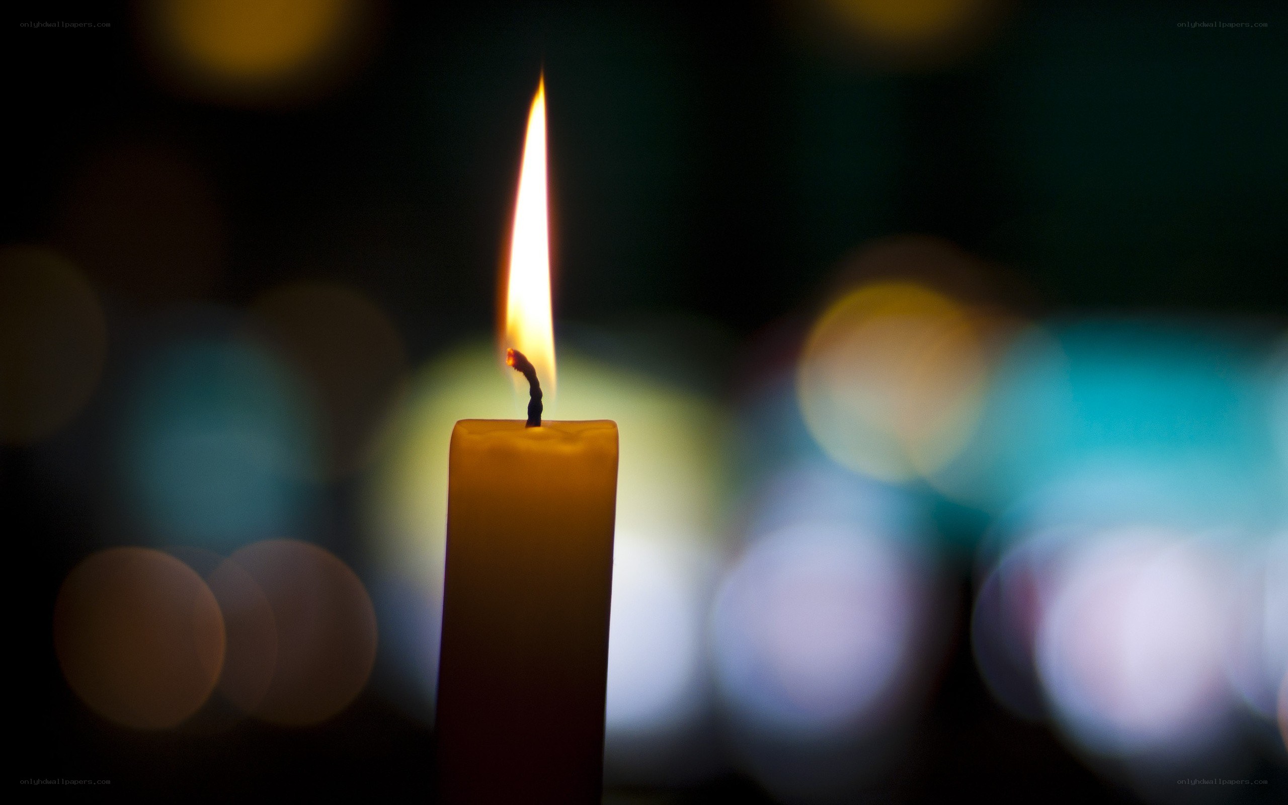 lit candle in dark