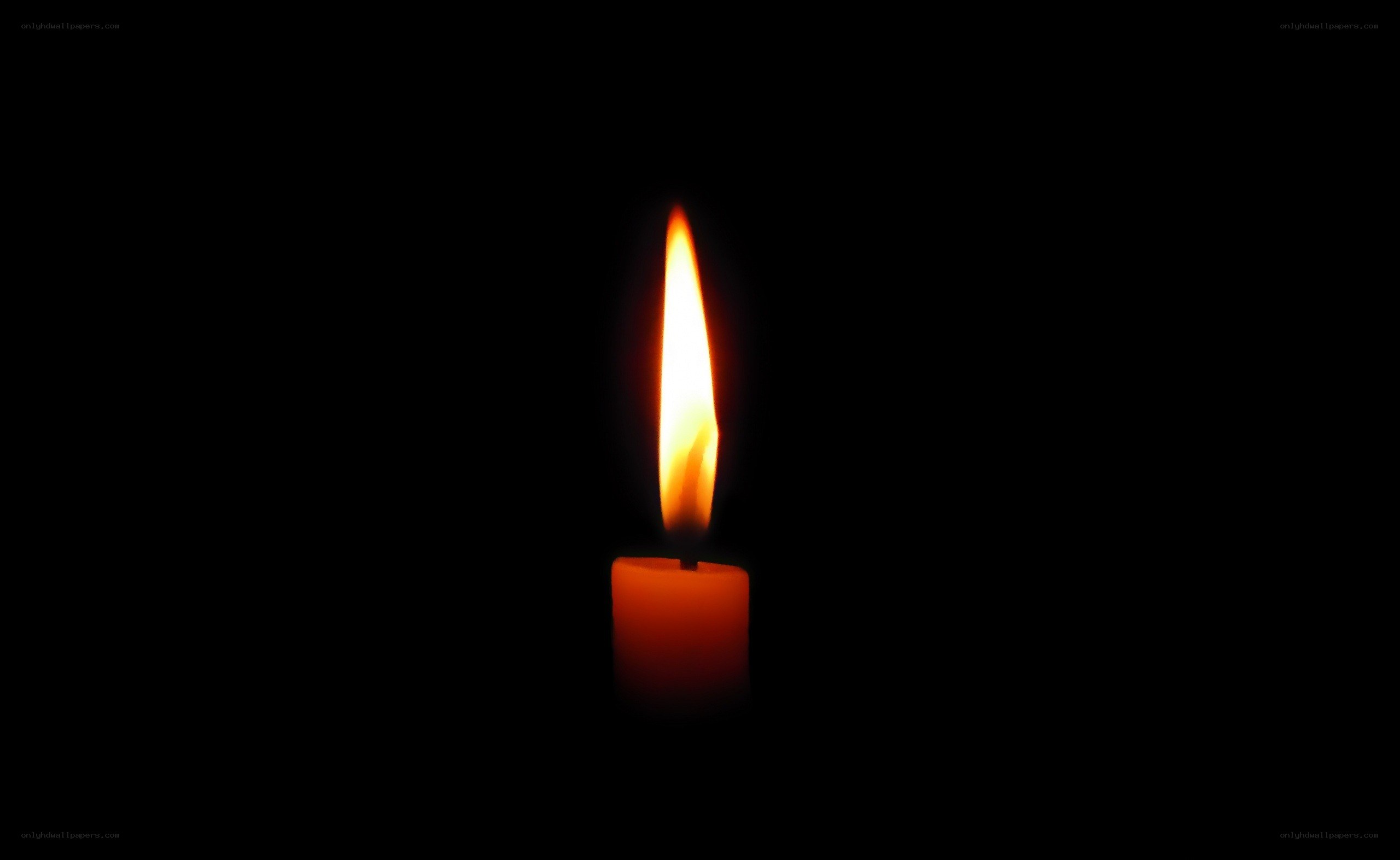 lit candle in darkness