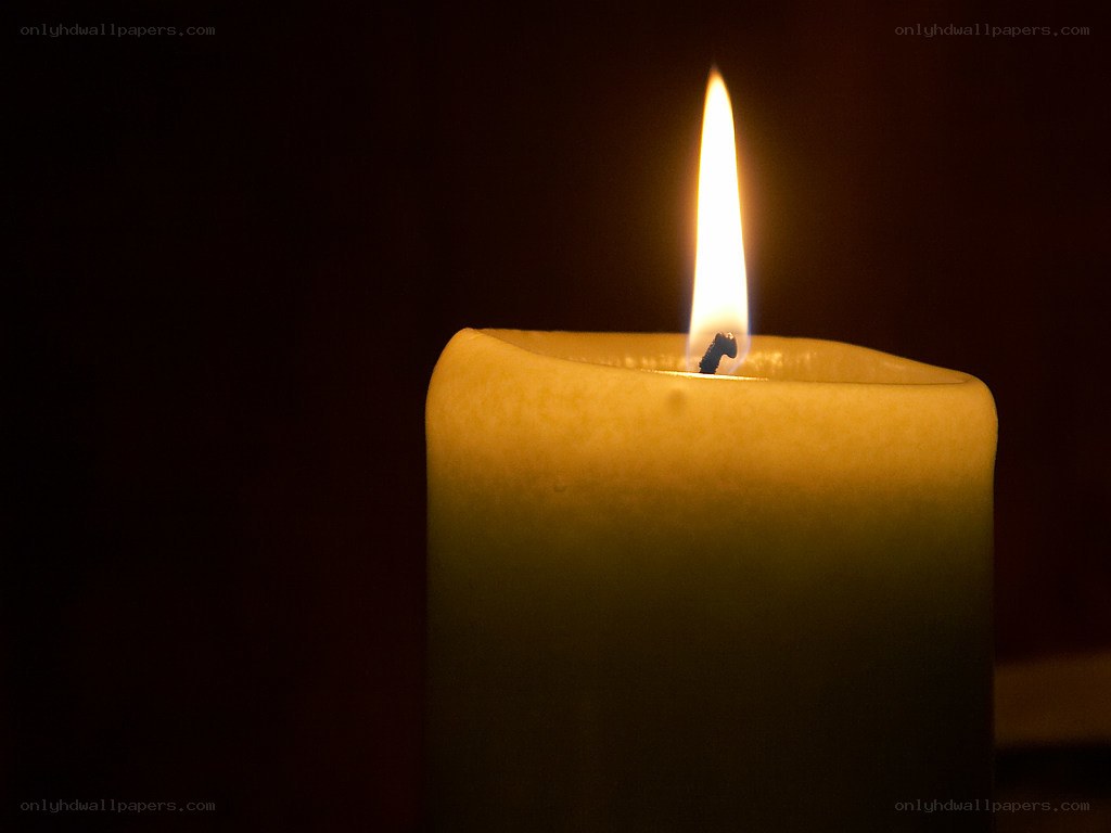lit candle in darkness