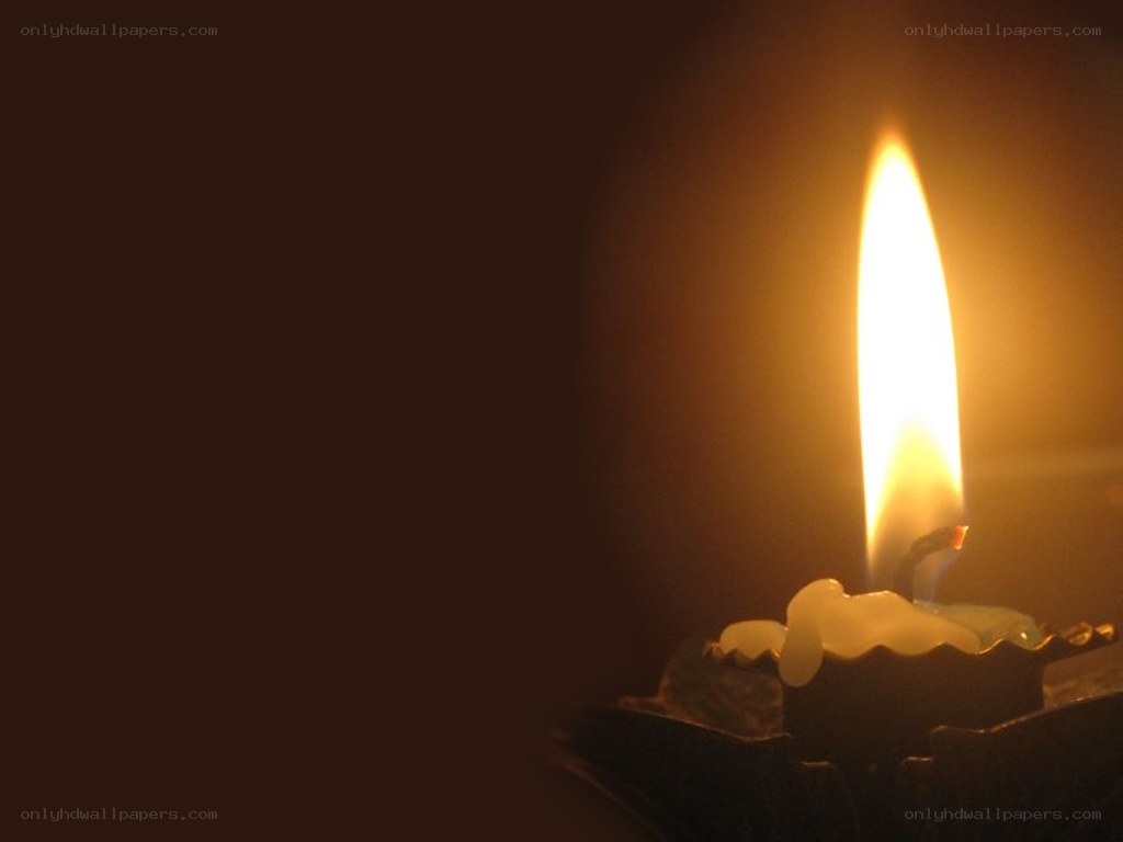 lit candle in darkness