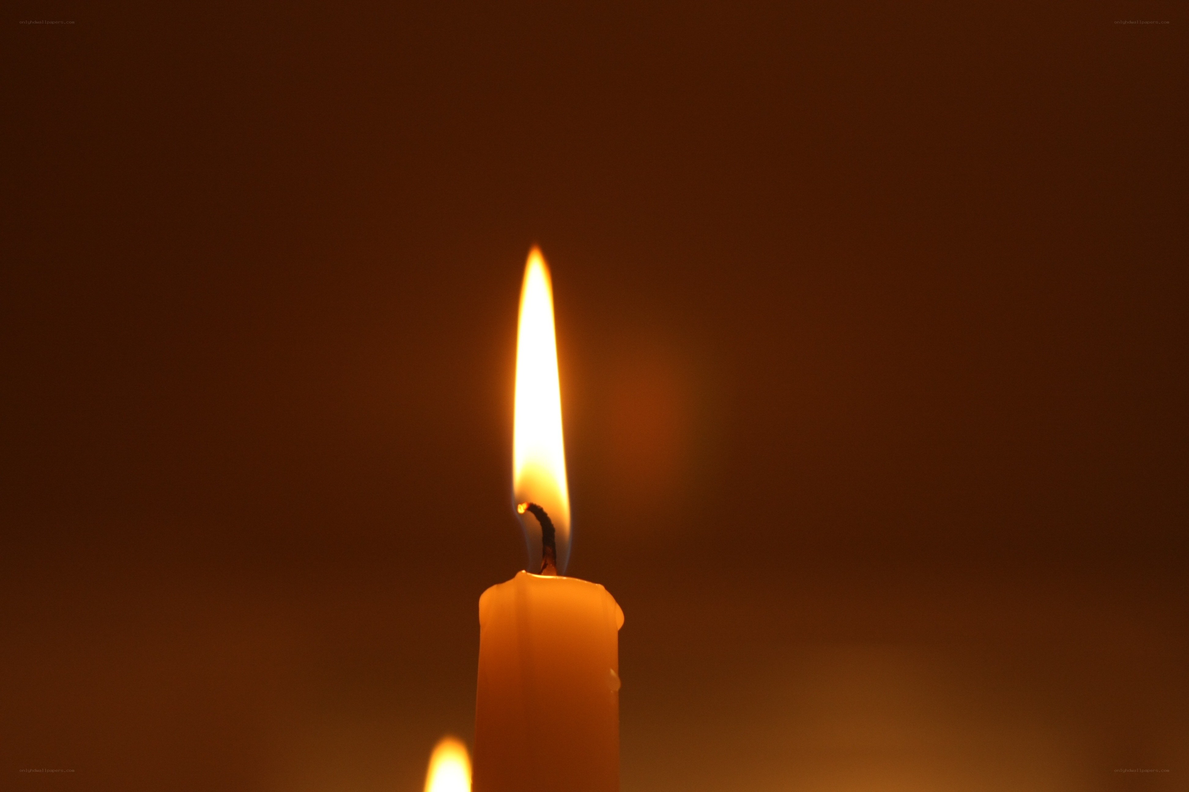 lit candle in darkness