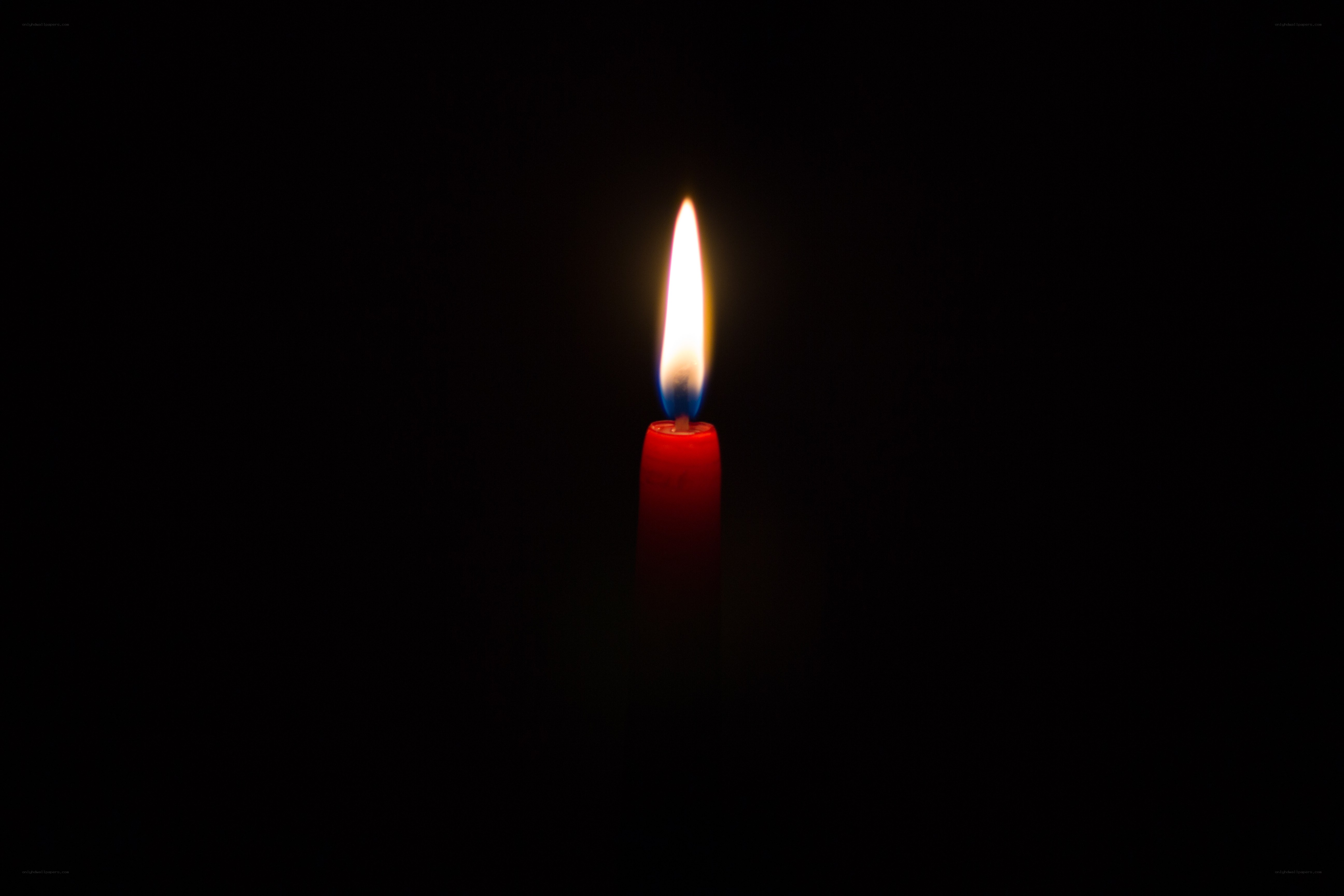 lit candle in darkness