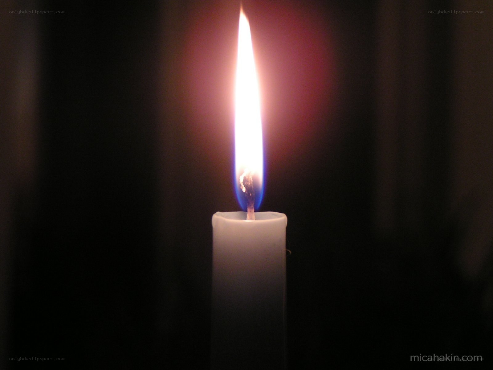 lit candle in darkness