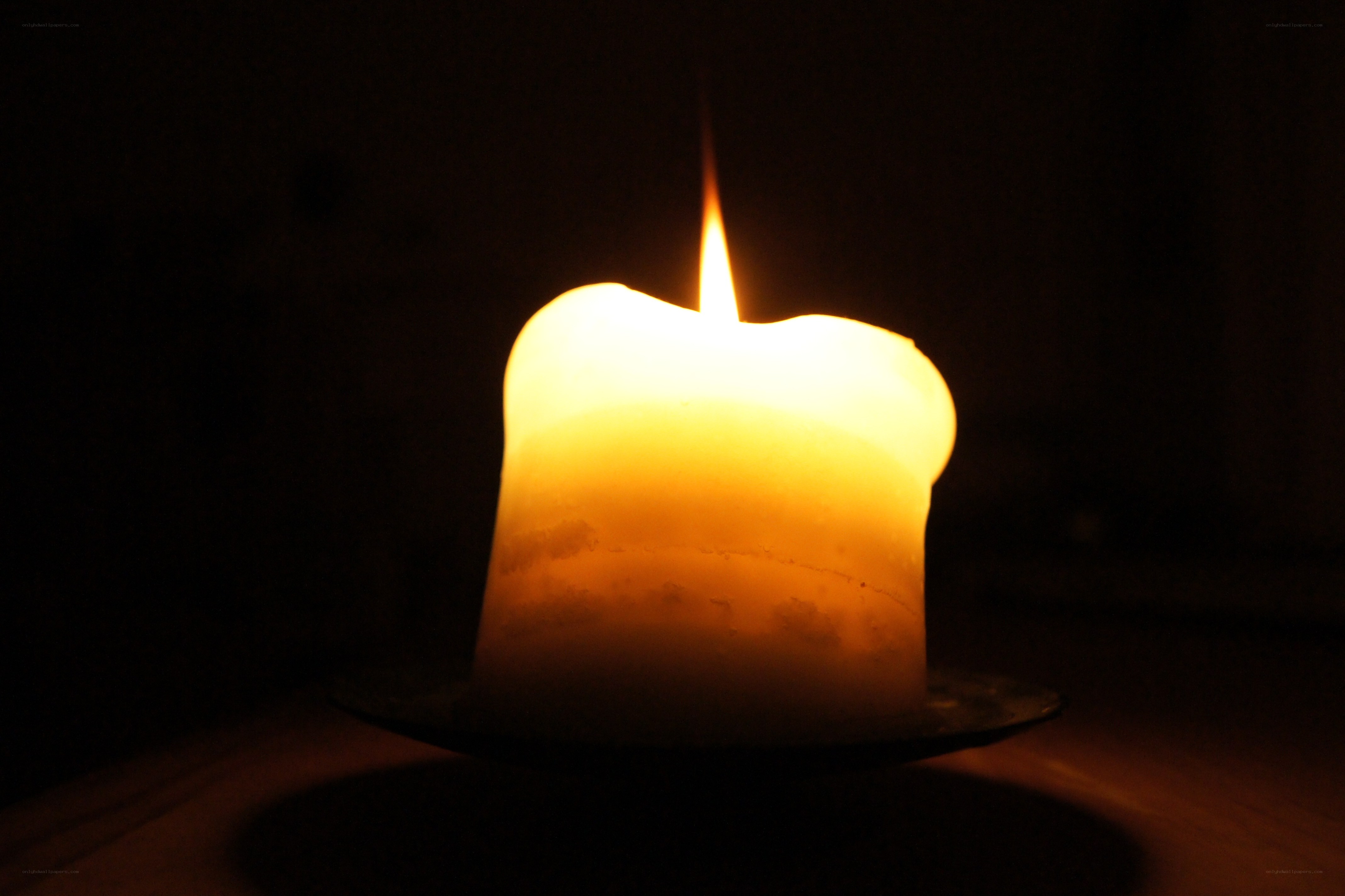 lit candle in darkness