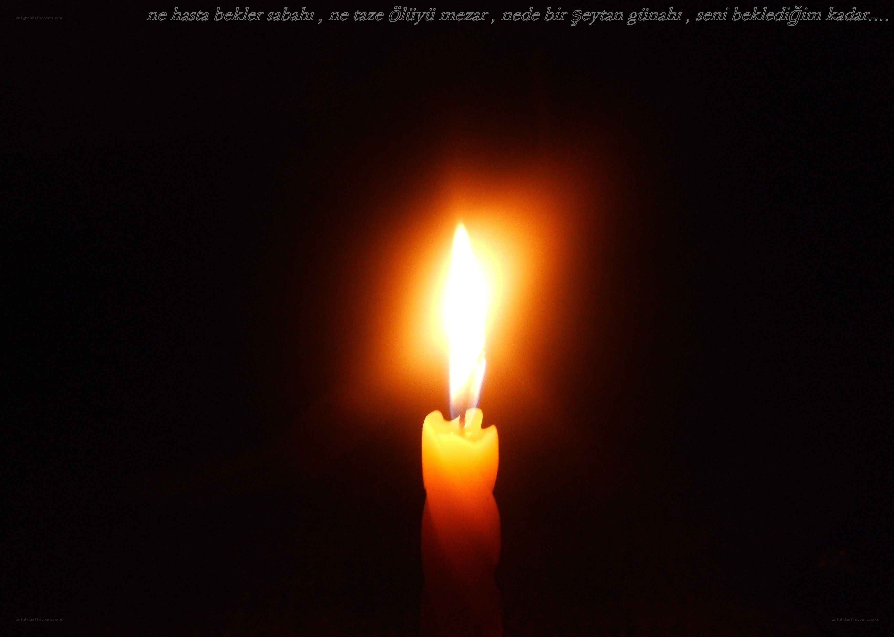 lit candle in darkness