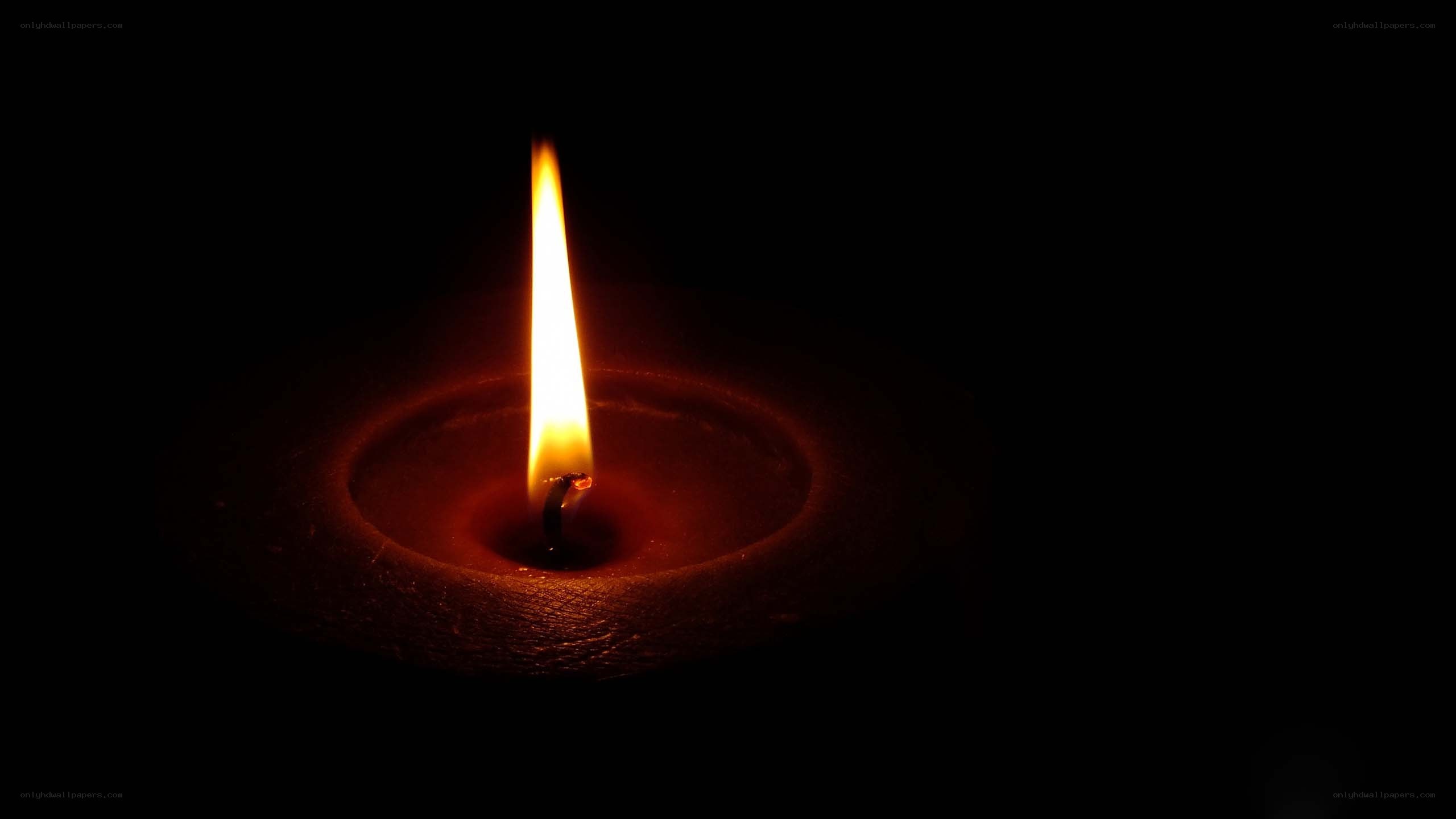 lit candle in darkness