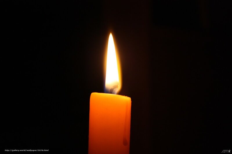 lit candle in darkness