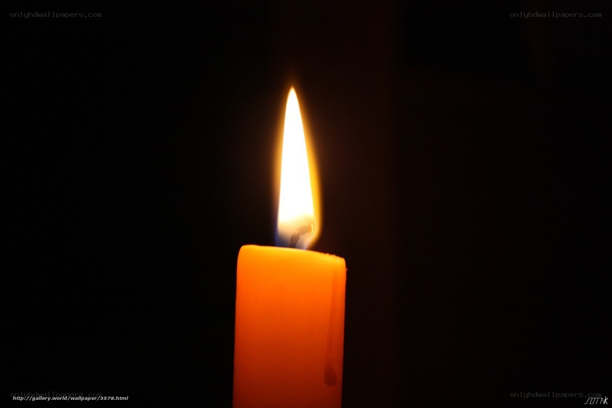 lit candle in darkness