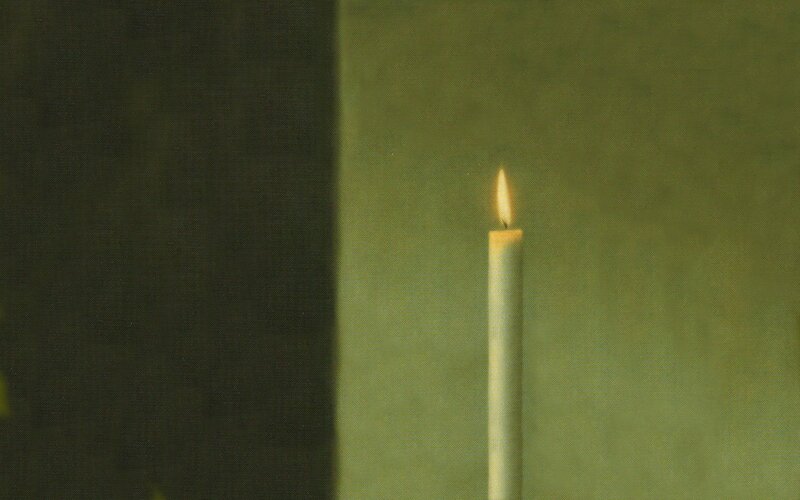 lit candle in dim light