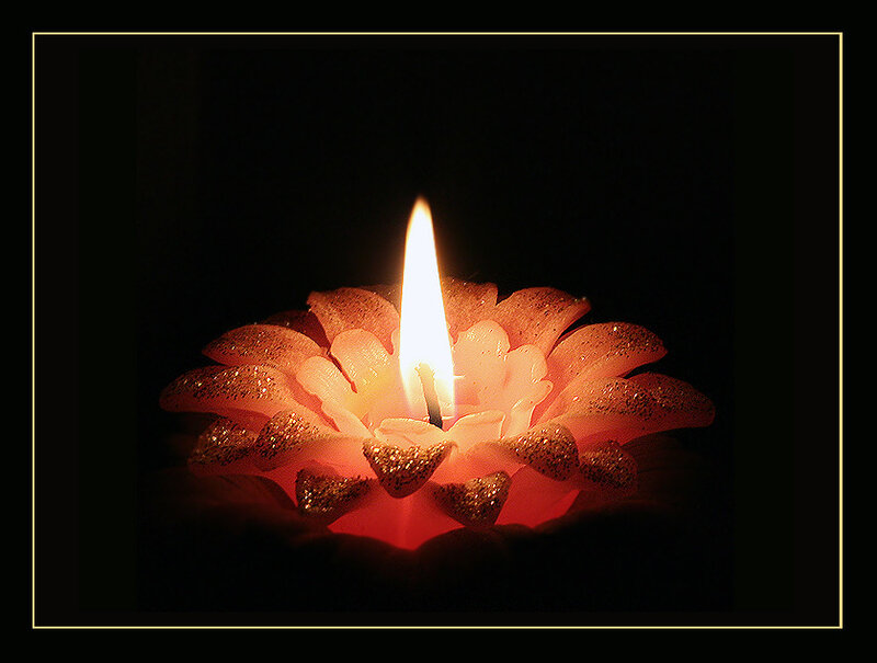 lit candle in flower shape