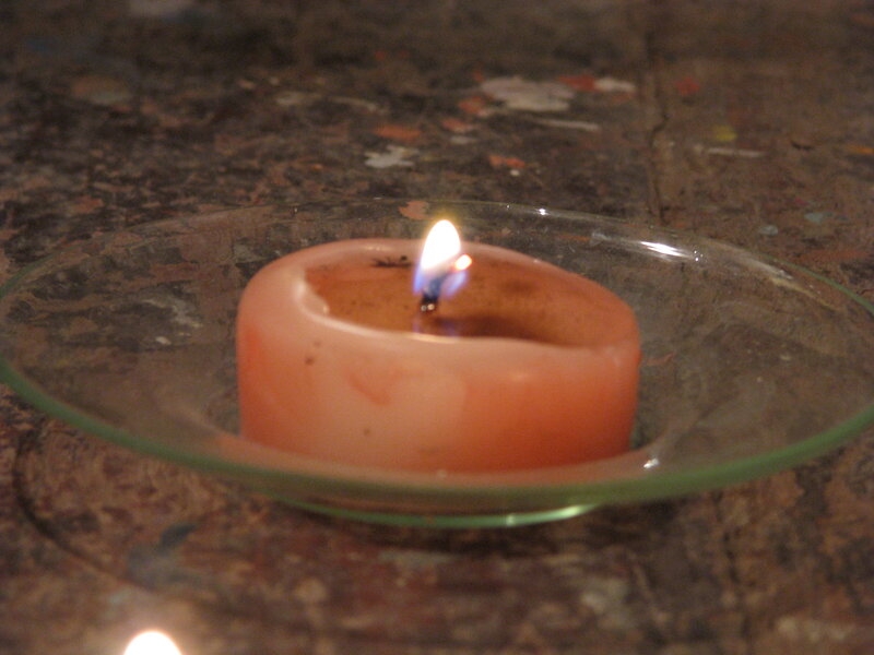 lit candle in glass dish