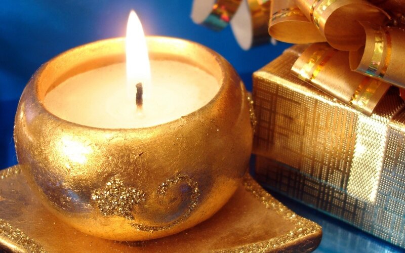Lit Candle in Gold Holder