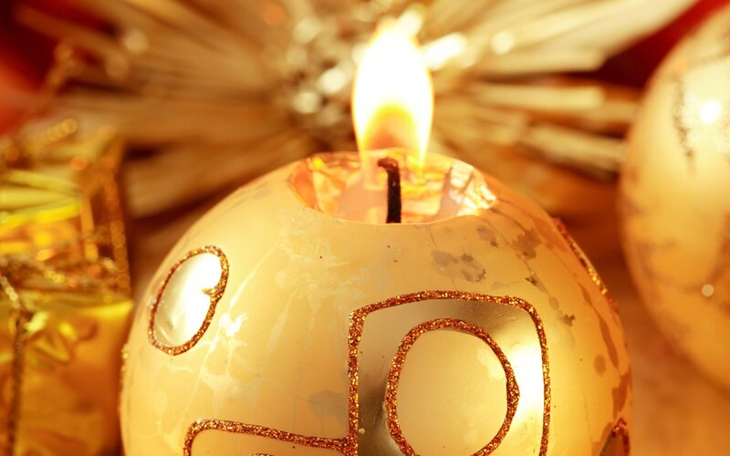 lit candle in golden ornament