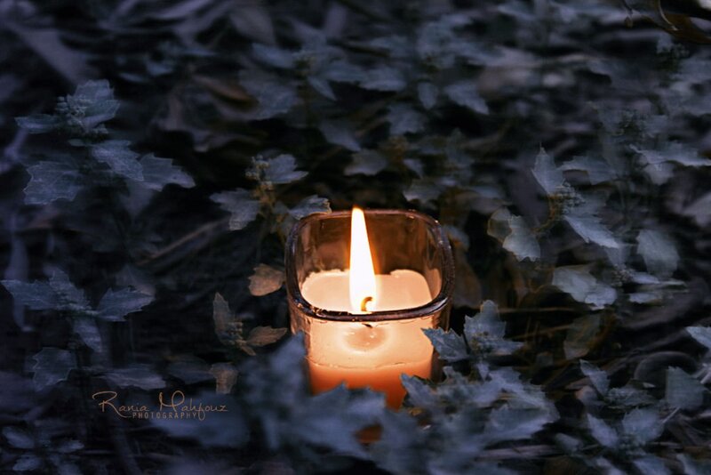 Lit Candle in Leaves