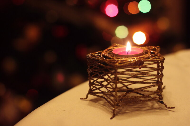Lit Candle in Wire Holder