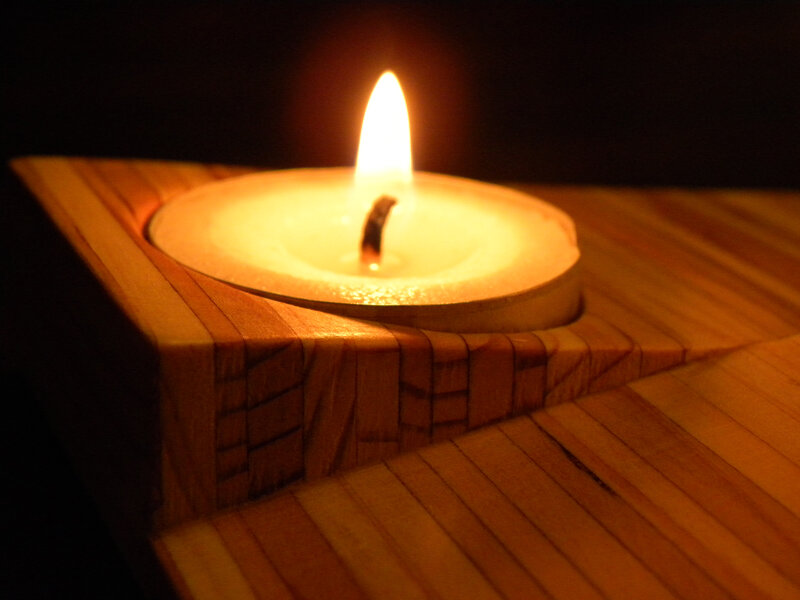 Lit Candle in Wooden Holder