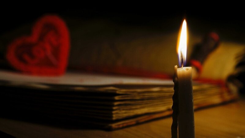 Lit Candle on Book
