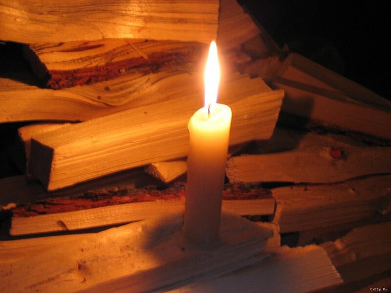 Lit Candle on Firewood
