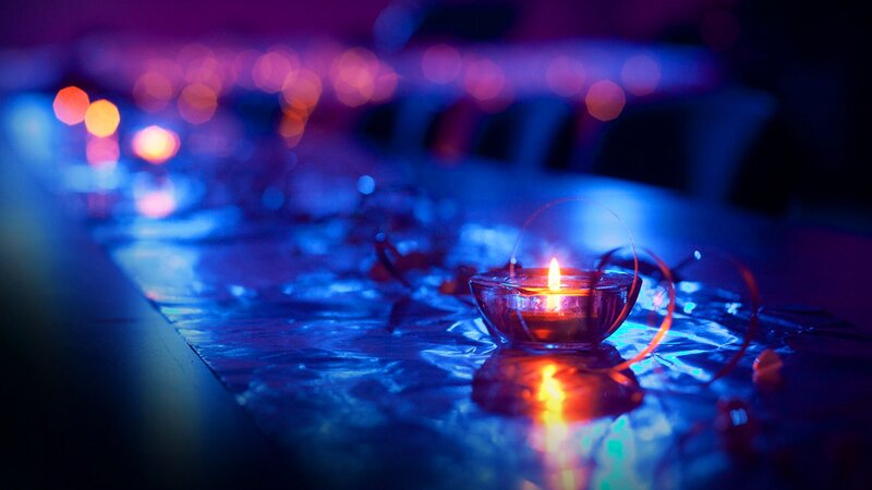Lit Candle on Table — Blue