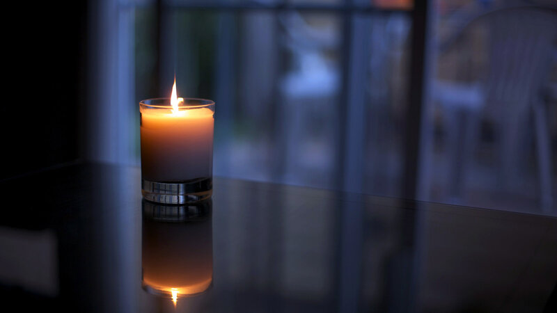 Lit Candle on Table — Orange
