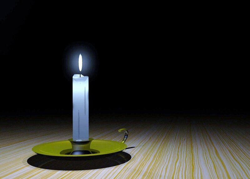 lit candle on wooden table