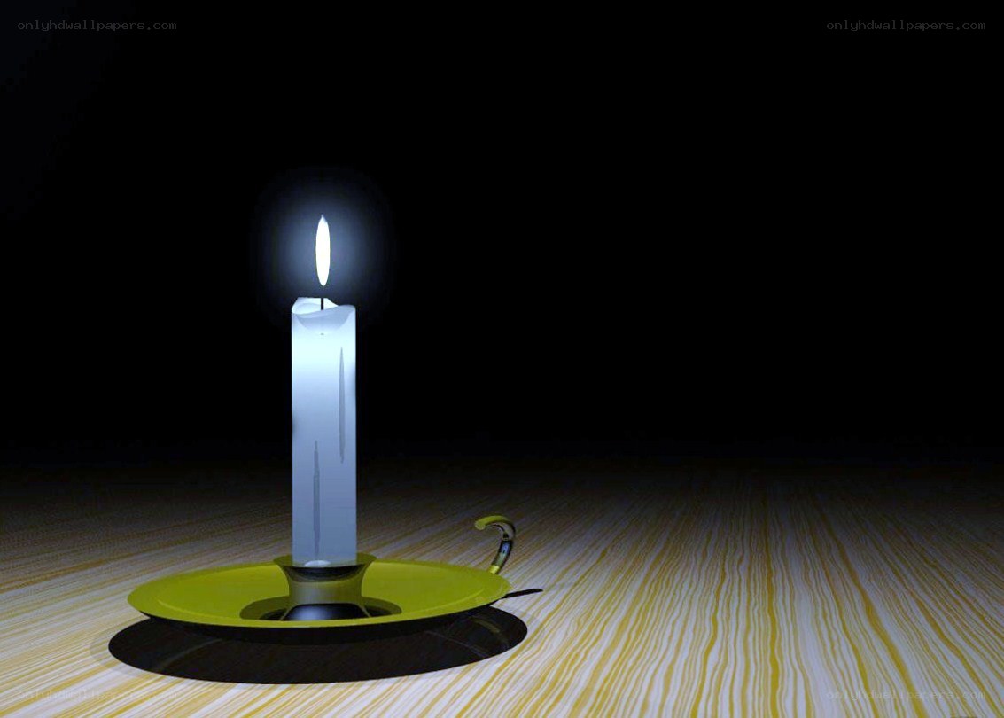 lit candle on wooden table