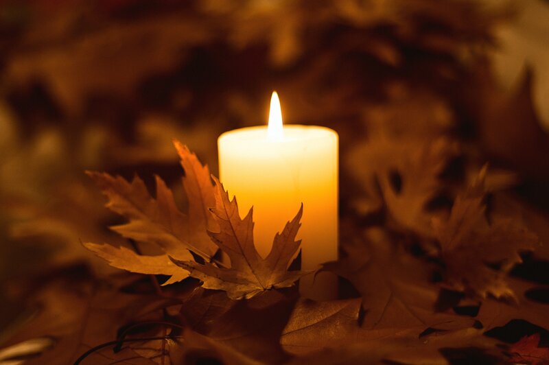 Lit Candle with Autumn Leaves — Orange