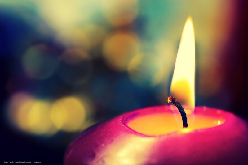 lit candle with colorful background