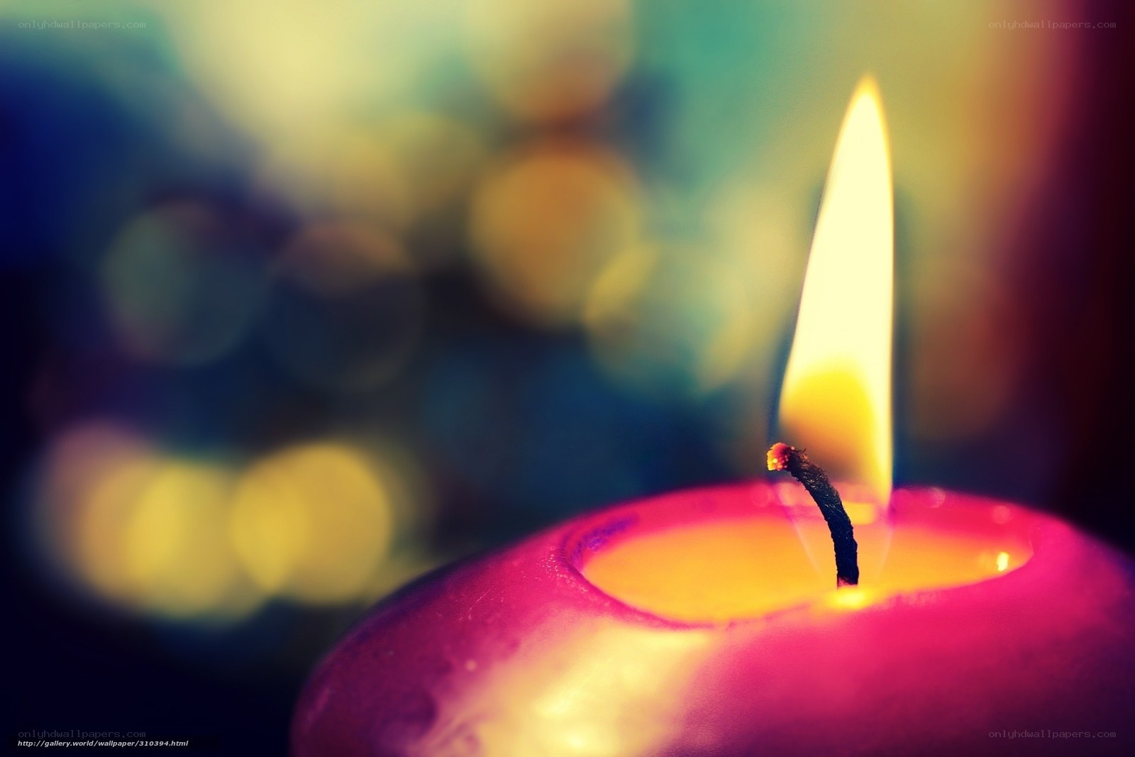 lit candle with colorful background