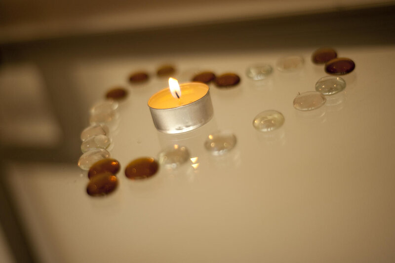 Lit Candle with Glass Pebbles