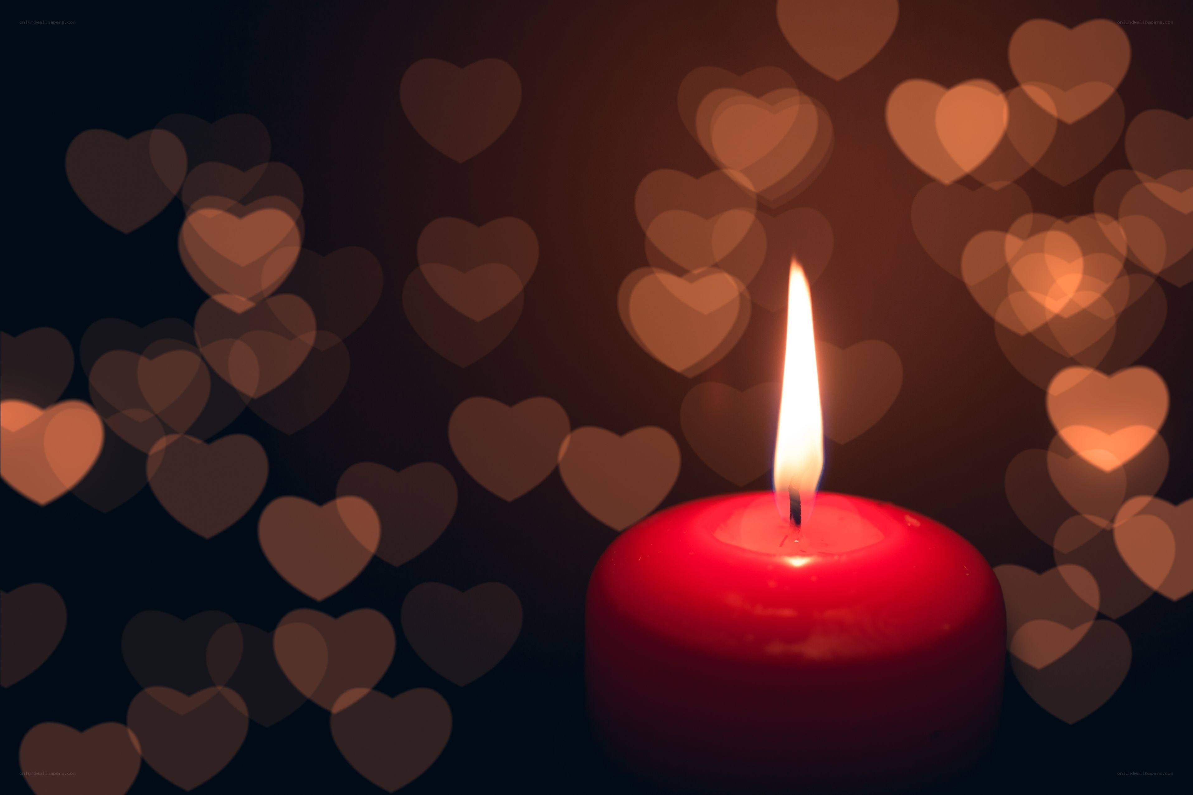 lit candle with heart bokeh