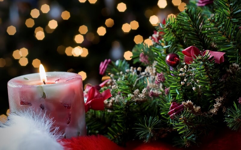 Lit Candle with Pine Branches