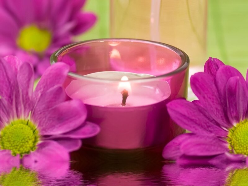 Lit Candle with Purple Flowers