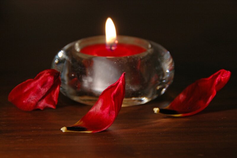 Lit Candle with Rose Petals