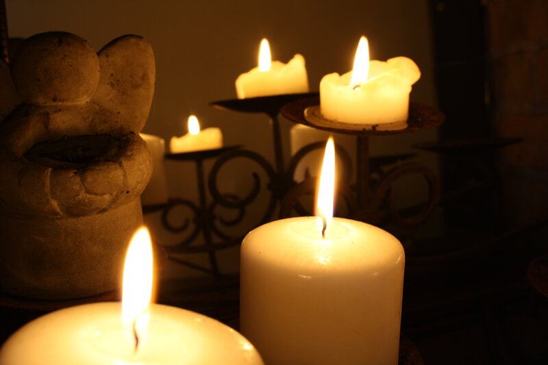 Lit Candles and Angel Statue