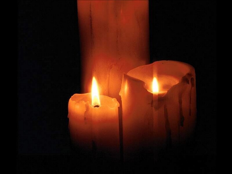 lit candles in darkness