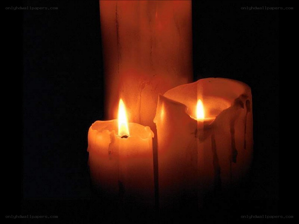 lit candles in darkness