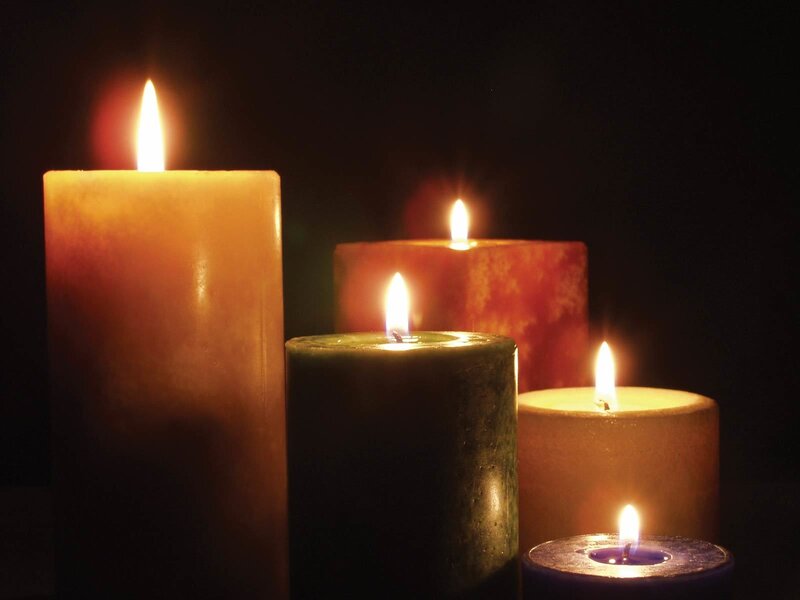 lit candles in darkness