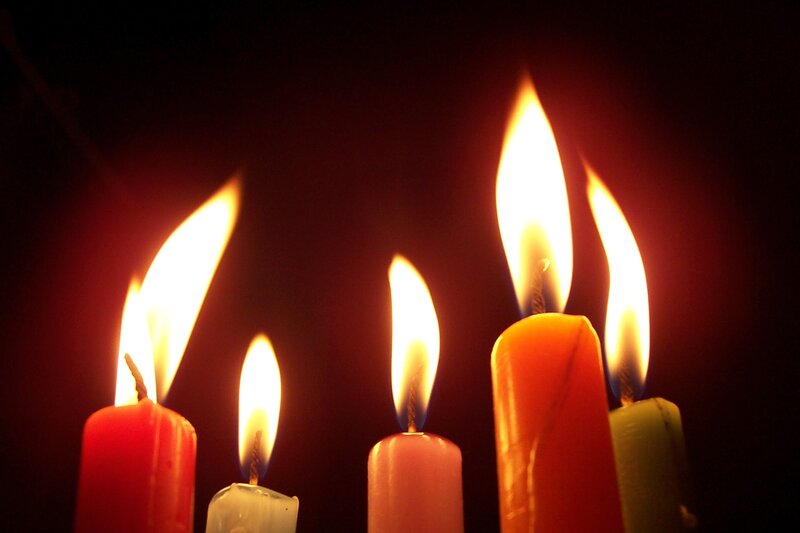 lit candles in darkness