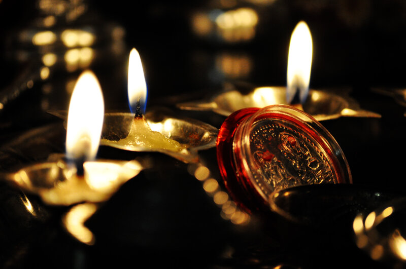 Lit Candles in Metal Holders