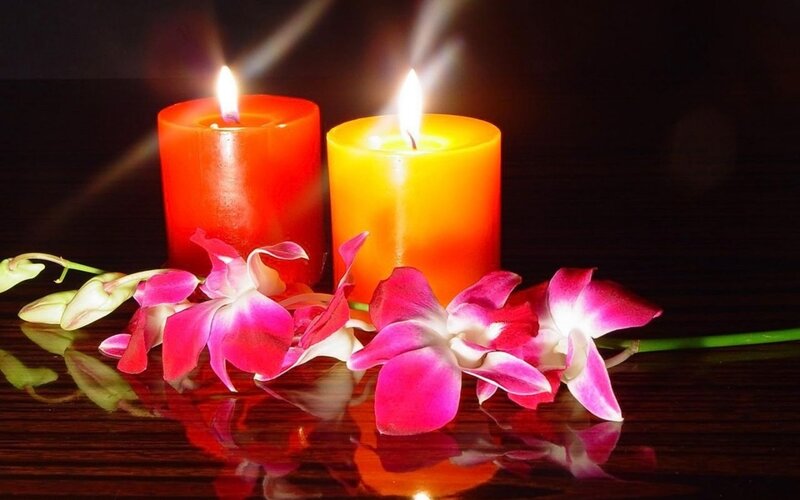 Lit Candles with Orchids