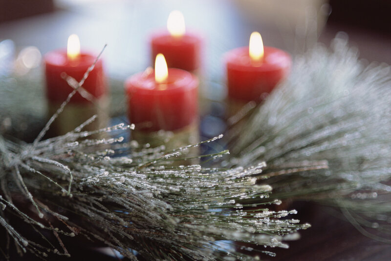 lit candles with pine branches
