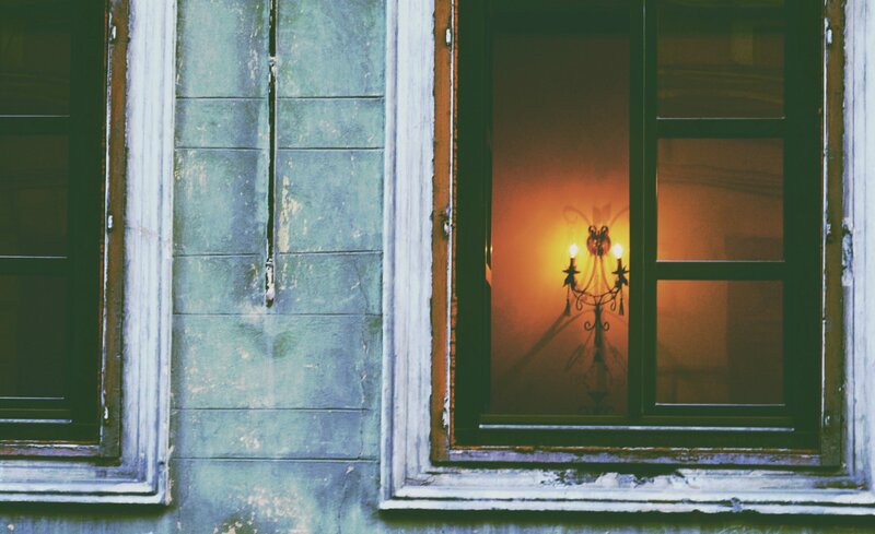 Lit Chandelier in Window