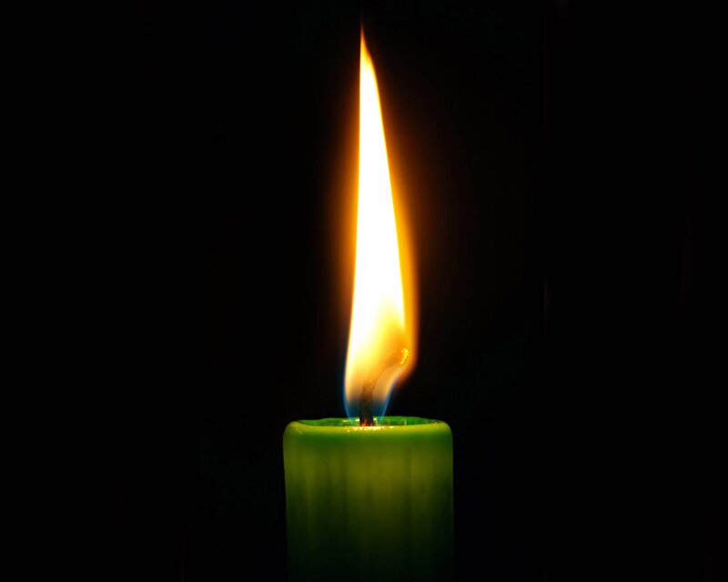 lit green candle flame