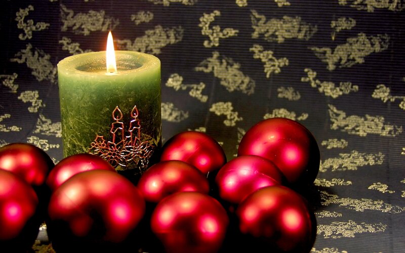 Lit Green Candle with Ornaments