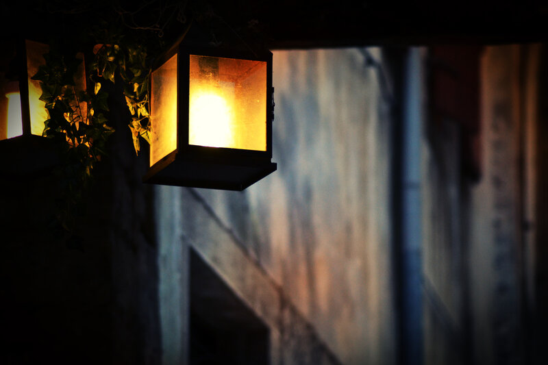 lit lantern in alleyway