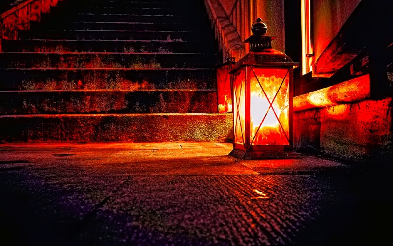 Lit Lantern on Stairs