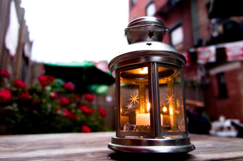 Lit Lantern on Table — Brown